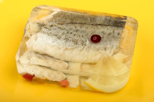 fish aspic with cranberries on the yellow plate