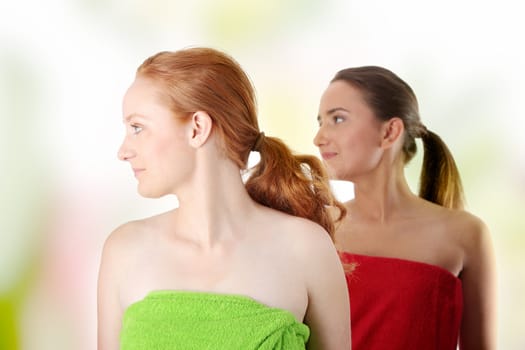 Spa - portrait of two woman - redhead and brunette - looking left