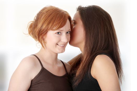 Two young womans talking gossip