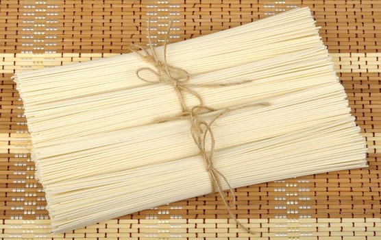 wheat noodles tied with rope on a mat