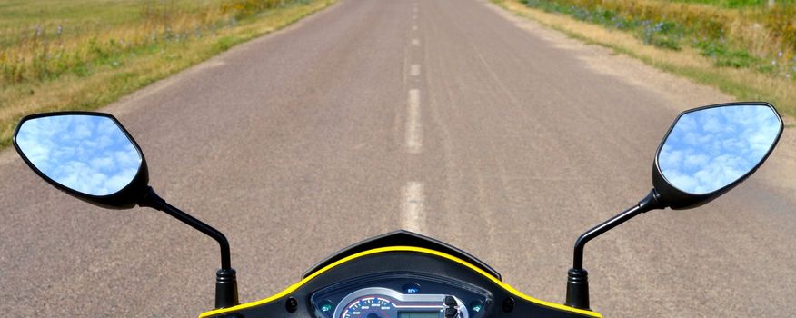 steering wheel scooter on the background of the asphalt road