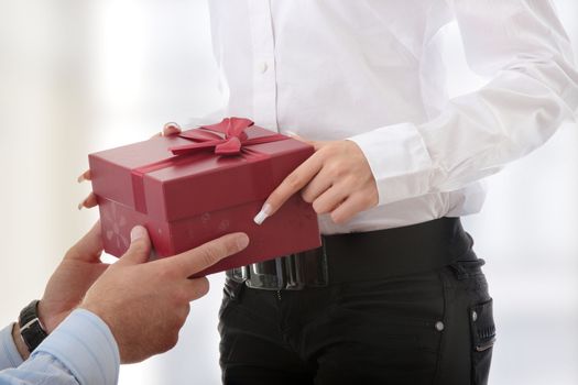 Business man offering a gift to a woman