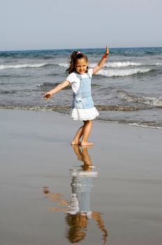 A sweet happy child and ocean in the background.