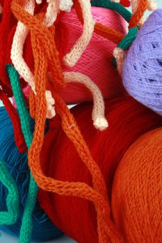 Colorful full woolen balls and threads randomly kept.