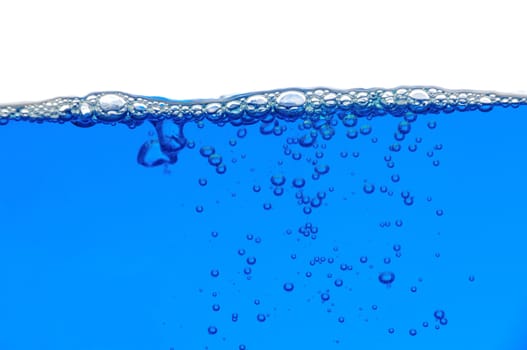 Blue water with air bubbles in the water line and under the water. Focus on the water line.