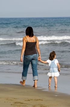 Mother and daughter together at the beach. 