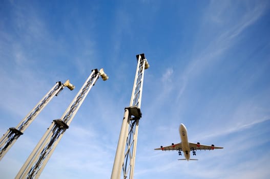 A plane is going to land in an airport. Note the plane is in motion blur