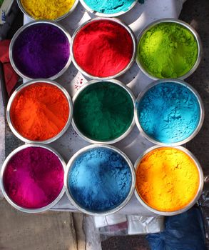 Bowls containing powders of different colors for the traditional celebration of the FESTIVAL OF COLORS - HOLI in India.