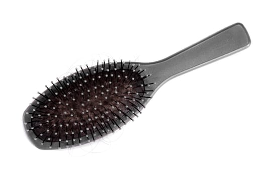 A dirty gray hairbrush on white background.