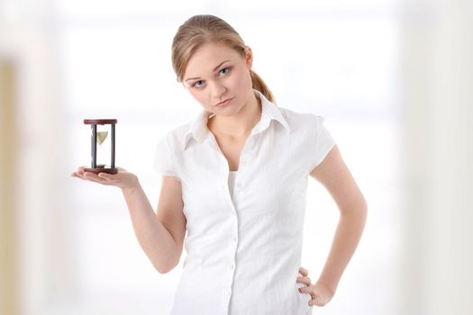 Young business woman with hourglass - time concept