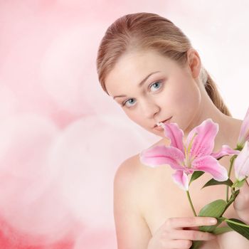 Portrait of young beautiful blond woman with lily flower