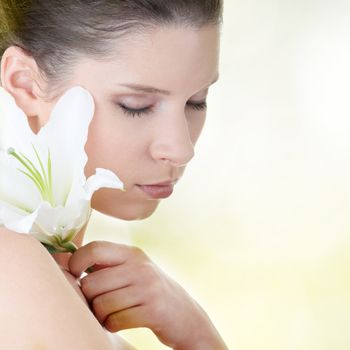 Portrait of fresh and beautiful woman with lily flower