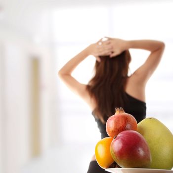 Healthy fruits with fitness girl in background
