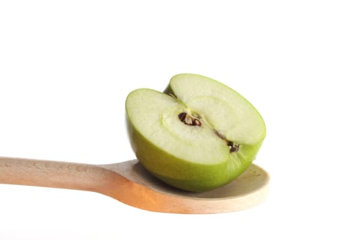 Apple on a wooden spoon isolated against a white background