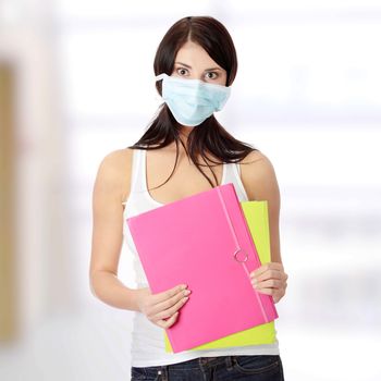 Caucasian student woman with mask on her face. She is defending her self from viruses.