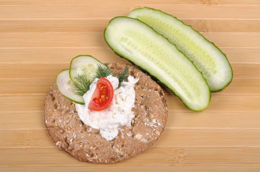 crispbread with curd cheese with cucumber and tomato