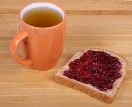 cup of tea and a sandwich with jam