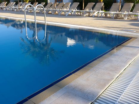 the poolside  and lounge chairs