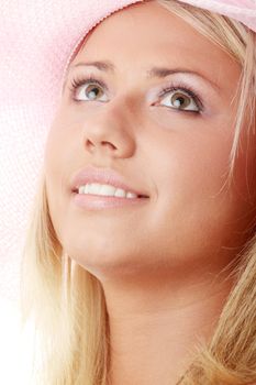 Portrait of an attractive young woman wearing a pink straw hat