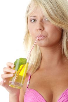 Beautiful young woman in pink bikini with cold drink (green tea)