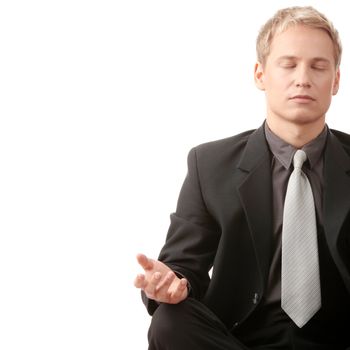 Businessman sitting in lotus position isolated