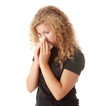 Young blonde woman having a cold close up isolated on white background