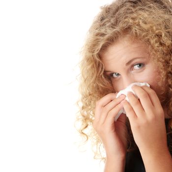 Young blonde woman having a cold close up isolated on white background