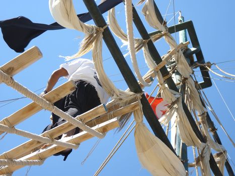 the masts of a ship and the sailor