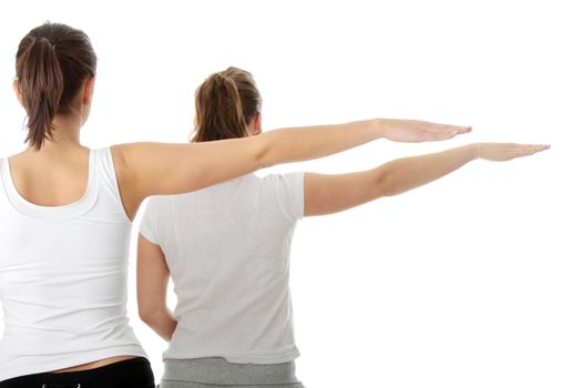 2 Beautiful young womans doing yoga exercise , isolated