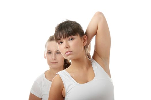 2 Beautiful young womans doing yoga exercise , isolated