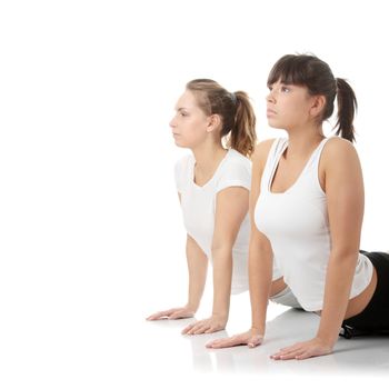 2 Beautiful young womans doing yoga exercise , isolated