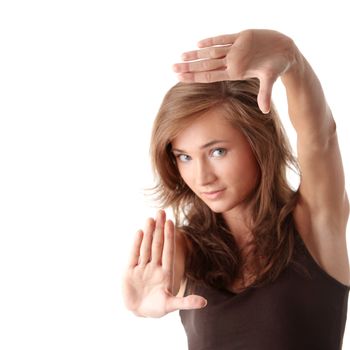 Young attractive woman framing her face with hands, over white