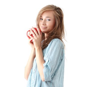 The beautiful young woman drinks morning coffee or tea