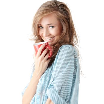 The beautiful young woman drinks morning coffee or tea