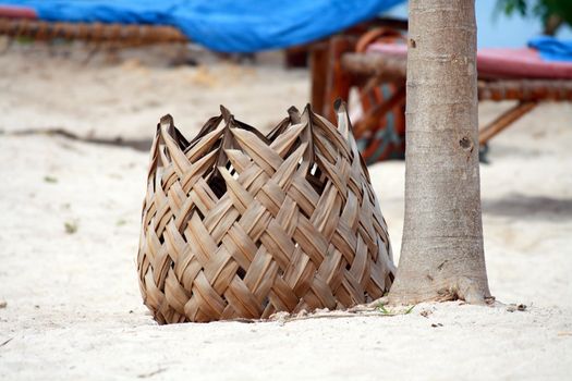 An unusual bin made of palm leaves