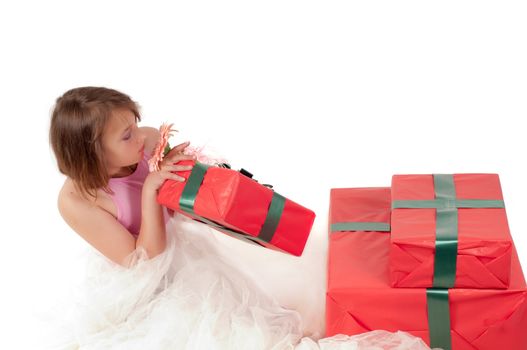 Teenager girl with presents in studio isolated on white