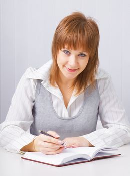 Girl with a notebook in the office. Business concept