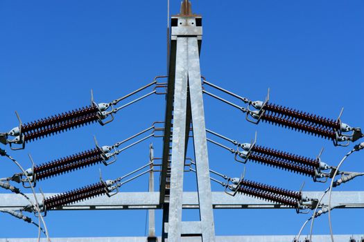 a utiliy pole against a blue sky