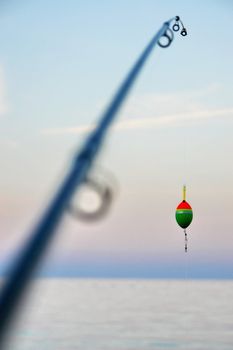 Fishing pole waiting to be cast, with line and sinker