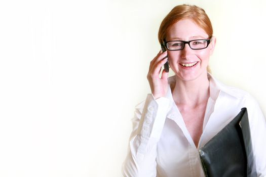 Friendly business woman with phone and briefcase
