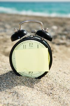 a closeup of an old clock on a beach