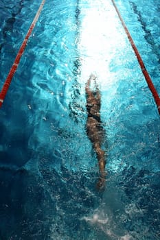 Swimmer in a swimming pool on a hot day