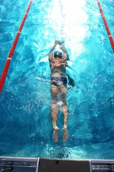 Swimmer in a swimming pool on a hot day