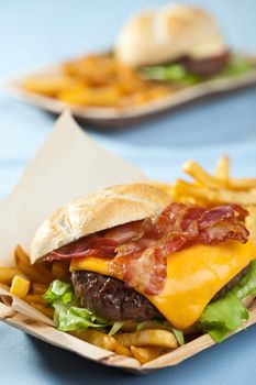 Big cheeseburger with bacon, fries and mayonaise