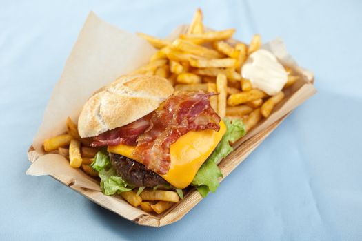 Big cheeseburger with bacon, fries and mayonaise