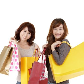 Shopping women, closeup portrait of two lady holding bags and smiling on white background.