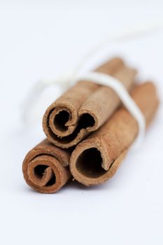 Three cinnamon spice Sticks on white