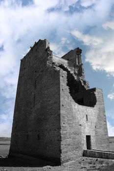 Ruins of a five-storeyed rectangular towerhouse within a bawn Partly destroyed in the 17th century in Ballylongford county kerry ireland