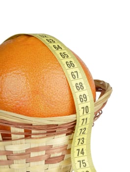 grapefruit in the basket and tape measure