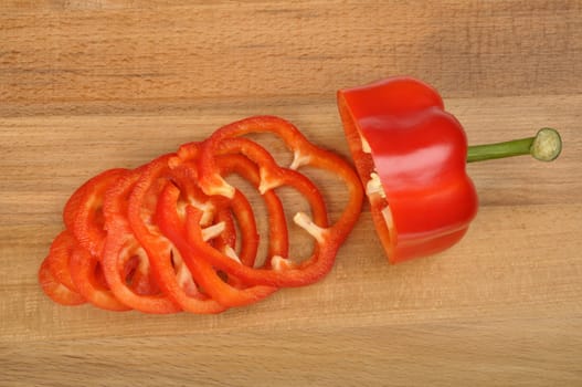 red pepper sliced on a worn cutting board